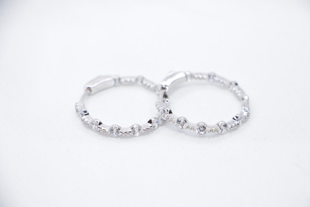 A pair of Lustrous Luxe Hoop Earrings crafted from 925 sterling silver, featuring bezel-set cubic zirconia stones in a sleek, lightweight hoop design, front view.