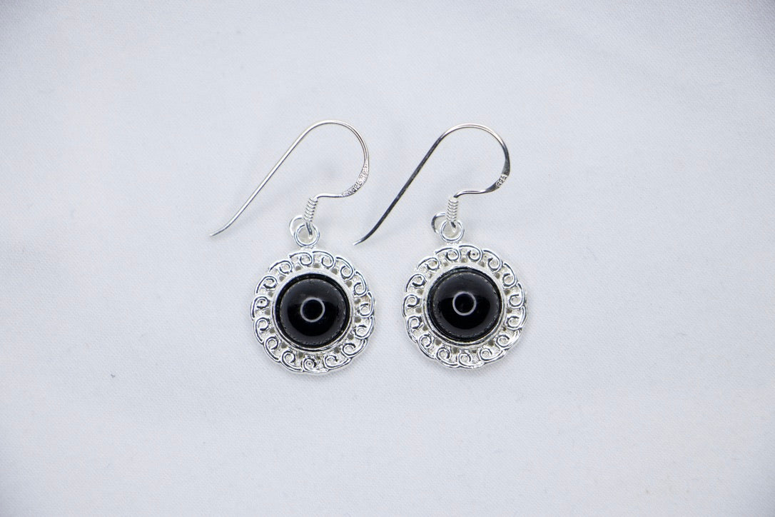 Midnight Elegance Drop Earrings featuring a black onyx gemstone encircled by intricate silver filigree, with a secure hook closure for an elegant look, top view.