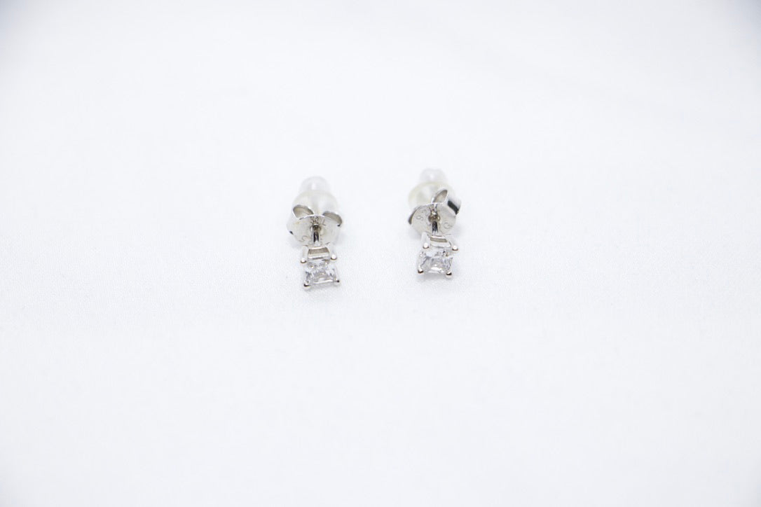Timeless Sparkle Stud Earrings featuring square-cut cubic zirconia stones set in sterling silver with a radiant sparkle, front view.