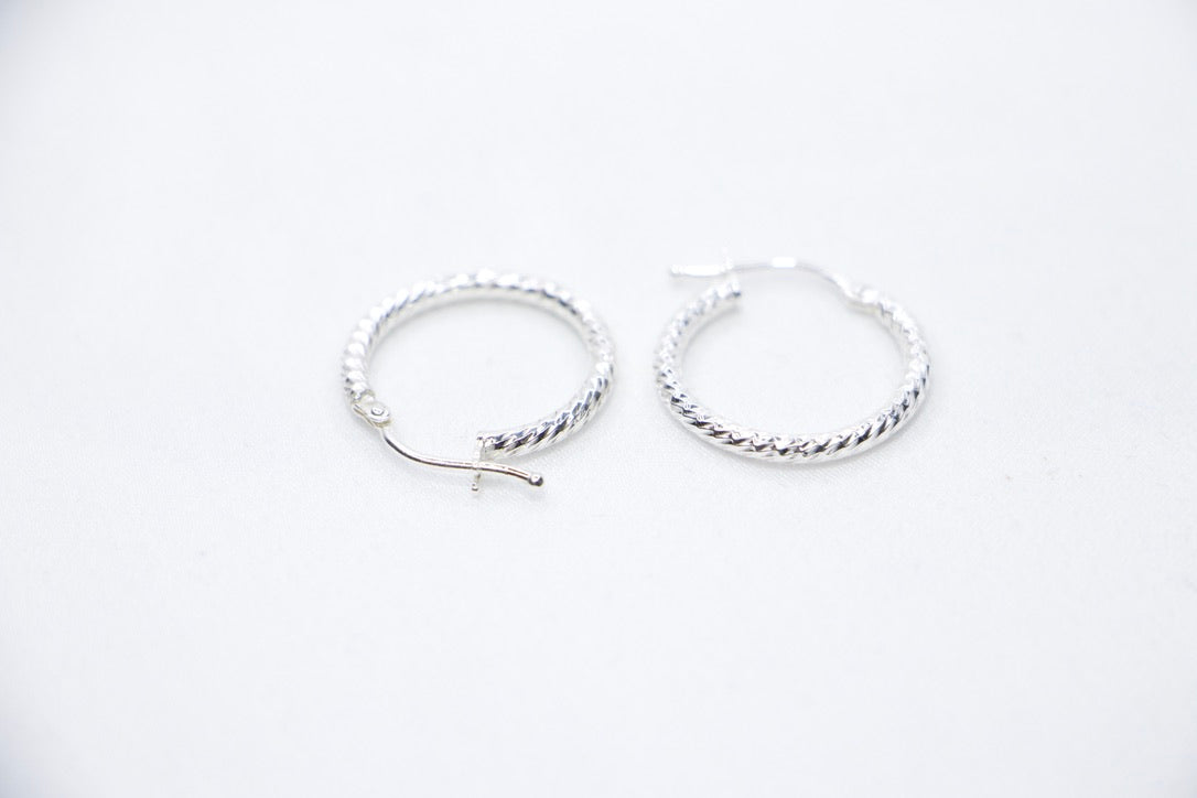 Twisted Luxe Hoop Earrings - Elegant Silver Design, Fine Jewelry for Women, top side view.