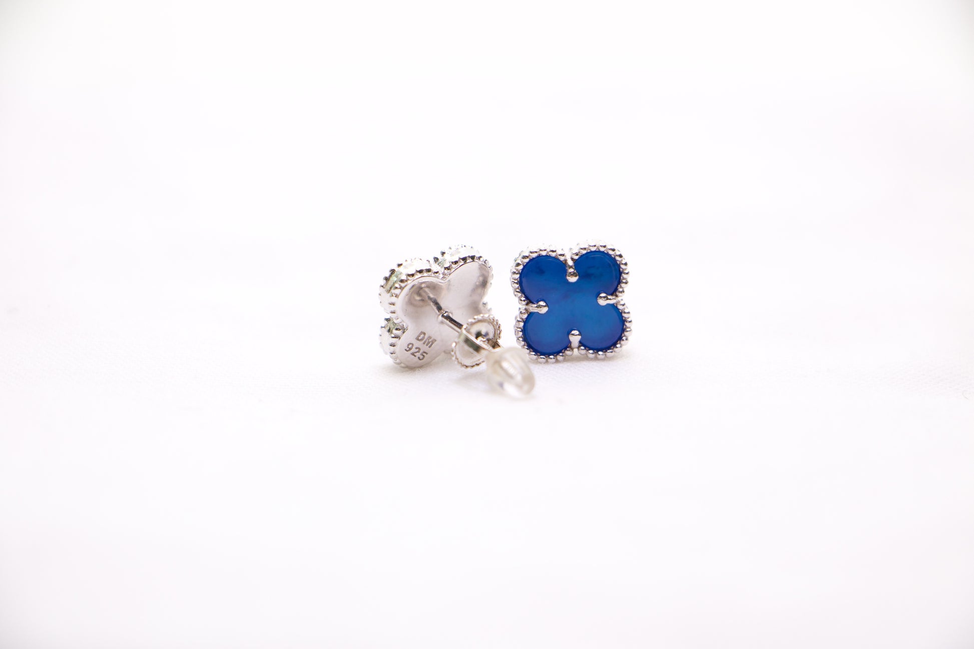 Sterling silver clover earrings with emerald blue enamel, hypoallergenic luxury studs for women.