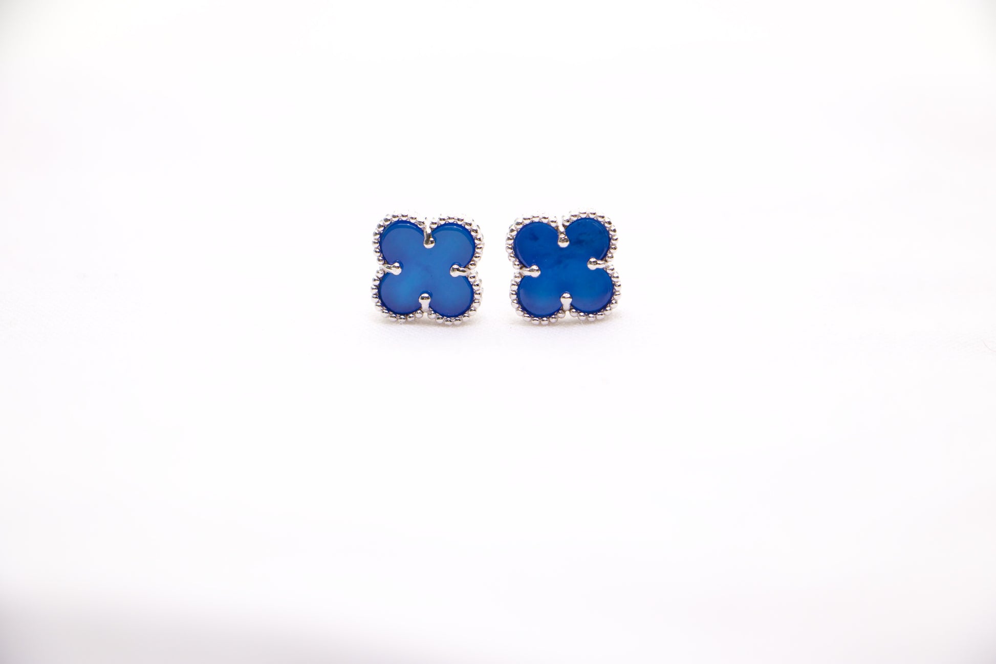 Sterling silver clover earrings with emerald blue enamel, hypoallergenic luxury studs for women.