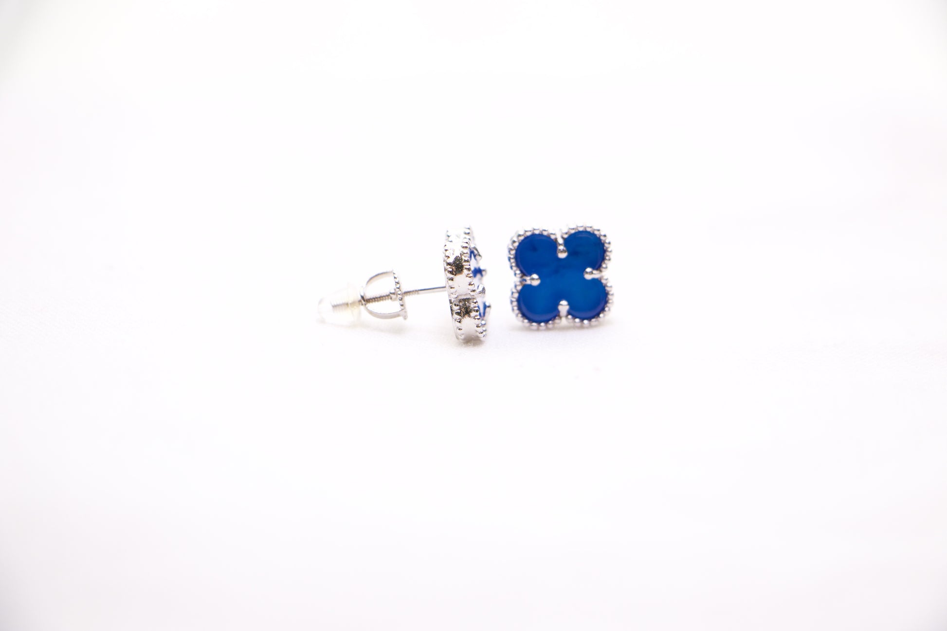 Sterling silver clover earrings with emerald blue enamel, hypoallergenic luxury studs for women.
