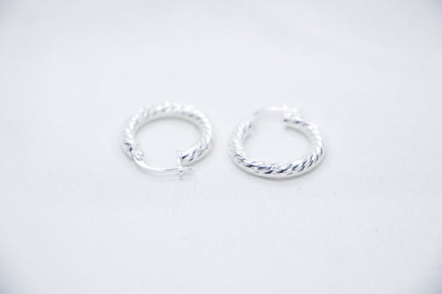 A Braided Radiance Hoop Earrings in sterling silver, featuring a sophisticated braided design that reflects light for a chic and radiant look, sides views. 
