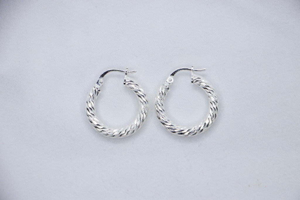 A Braided Radiance Hoop Earrings in sterling silver, featuring a sophisticated braided design that reflects light for a chic and radiant look, top views. 