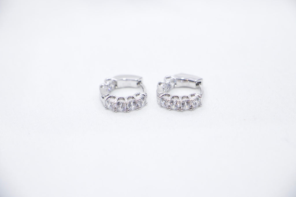 White gold diamond hoop earrings, elegant minimalist design, timeless, luxury fine jewelry front view.
