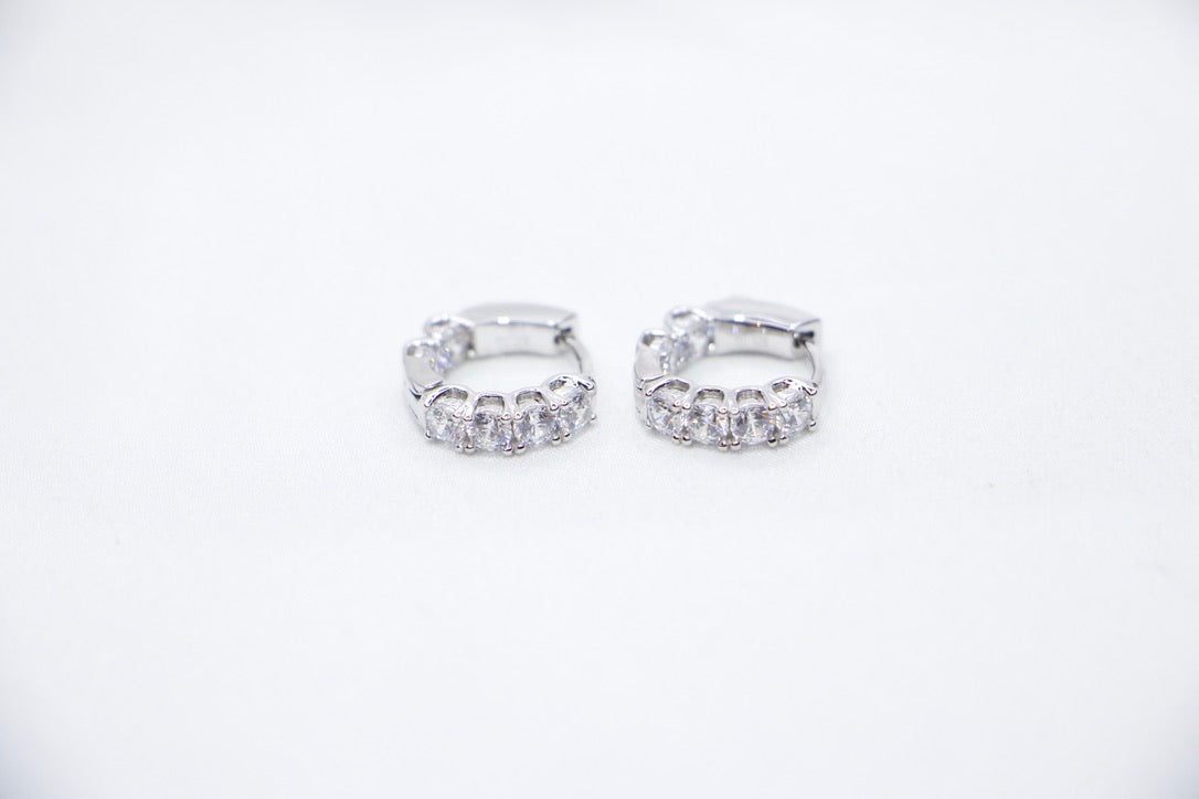 White gold diamond hoop earrings, elegant minimalist design, timeless, luxury fine jewelry front view.