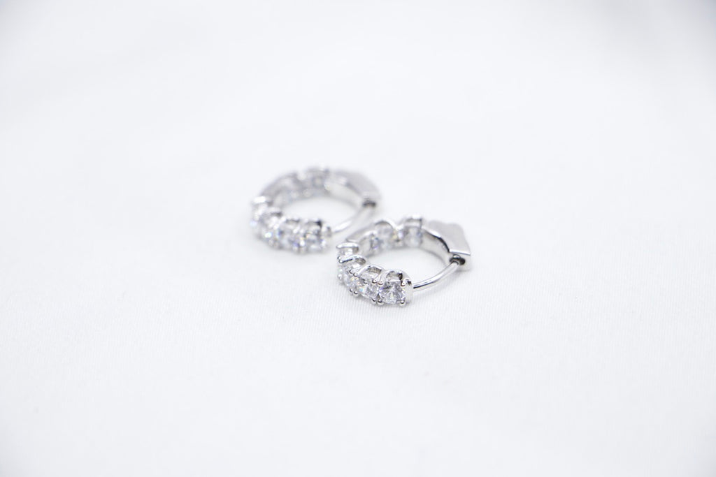 White gold diamond hoop earrings, elegant minimalist design, timeless, luxury fine jewelry front side view.