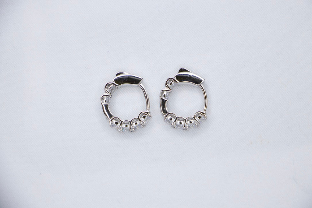 White gold diamond hoop earrings, elegant minimalist design, timeless, luxury fine jewelry top side view.