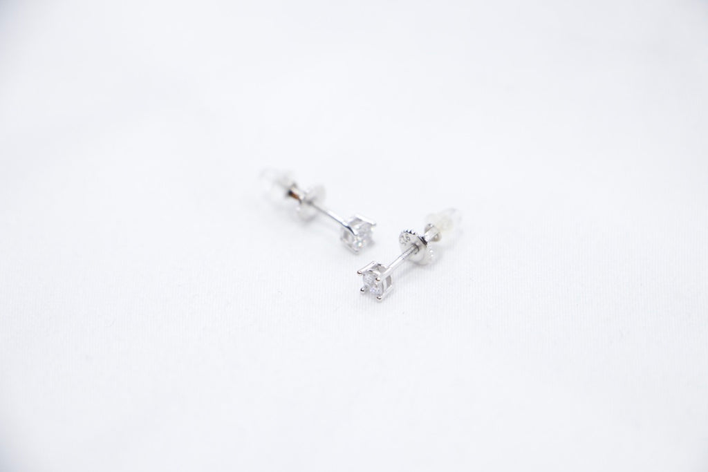  A Classic Radiance Stud Earrings featuring square-cut cubic zirconia stones set in sterling silver, sides top view.