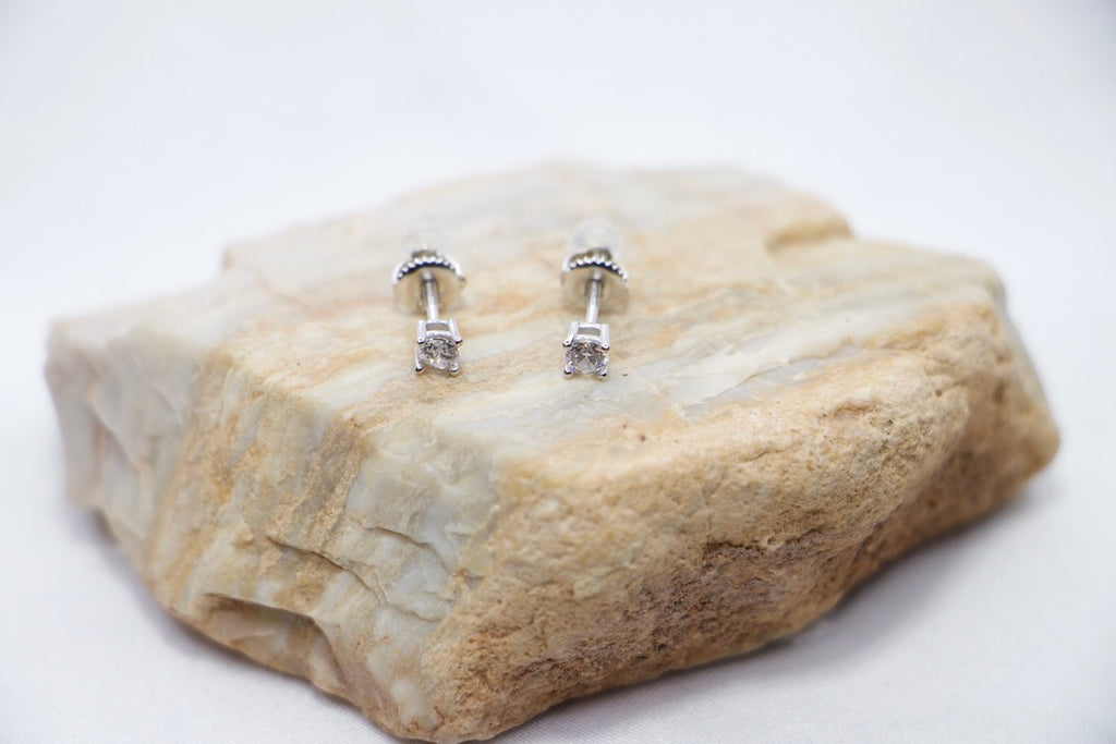  A Classic Radiance Stud Earrings featuring square-cut cubic zirconia stones set in sterling silver, top front rock view.
