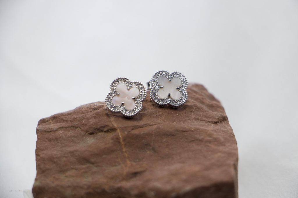 Dazzling Clover Stud Earrings in Sterling Silver with Sparkling Gemstones - Elegant Jewelry front view rock. 