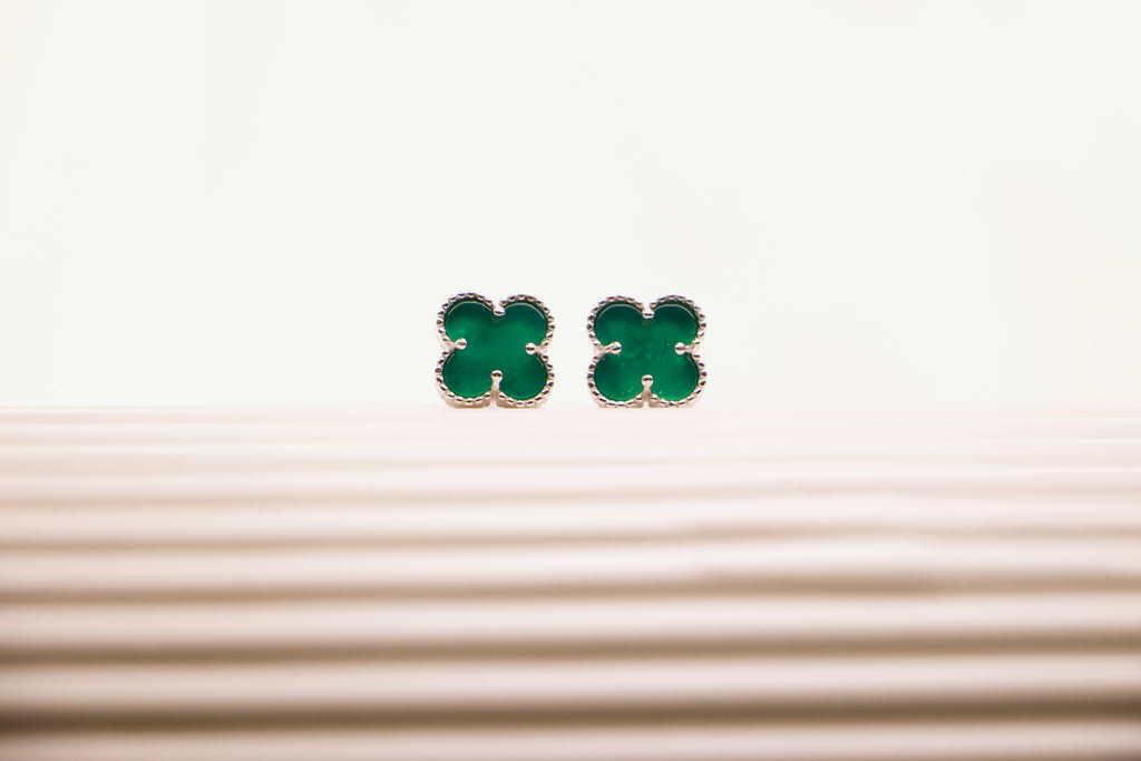 Sterling silver clover earrings with emerald green enamel, hypoallergenic luxury studs for women.