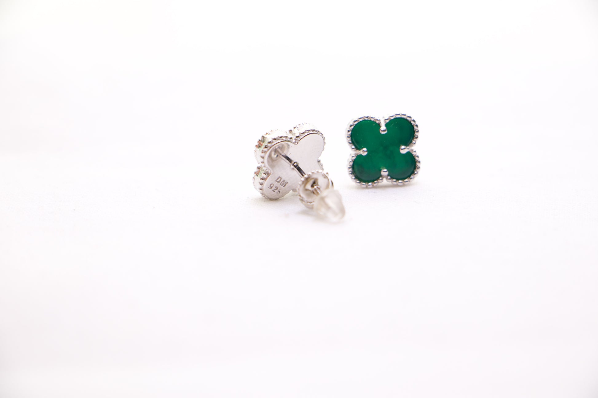 Sterling silver clover earrings with emerald green enamel, hypoallergenic luxury studs for women.