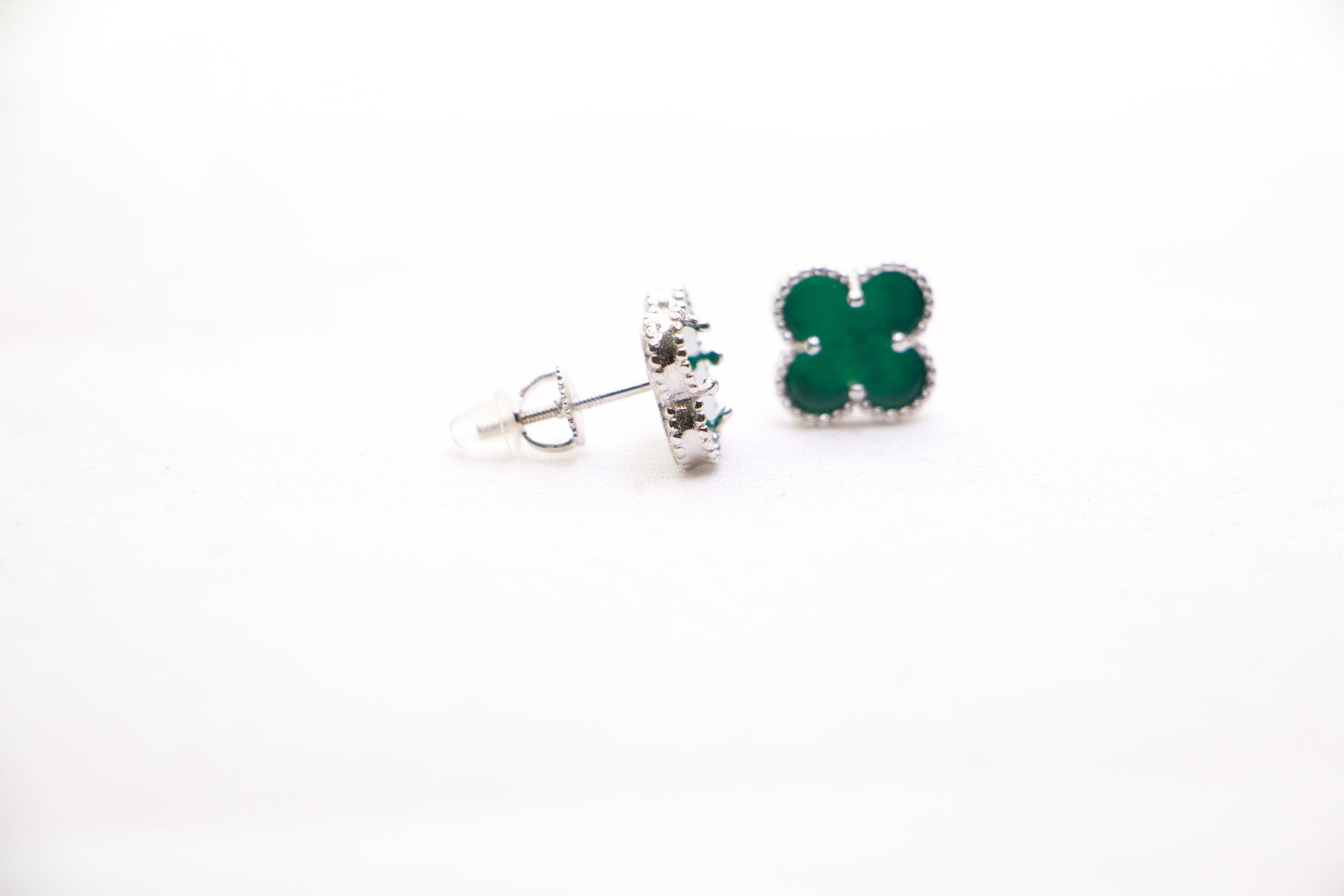 Sterling silver clover earrings with emerald green enamel, hypoallergenic luxury studs for women.