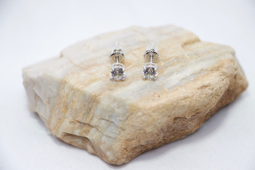 Eternal Glow Stud Earrings featuring square-cut cubic zirconia stones set in sterling silver, a sleek and sparkling design with a secure butterfly-back closure, front rock view.