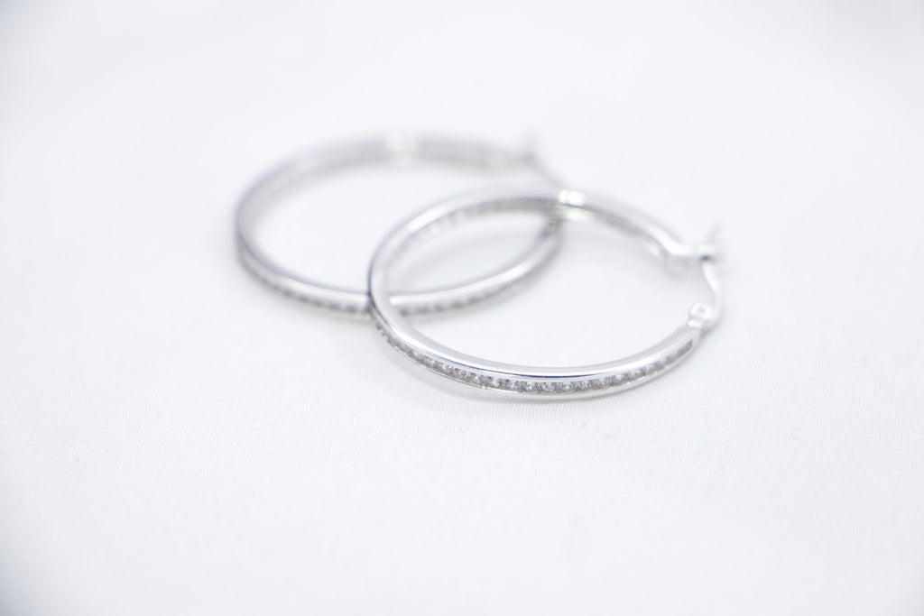 Sterling Silver Hoop Earrings with Cubic Zirconia - Elegant, Hypoallergenic Jewelry for Women front side view.