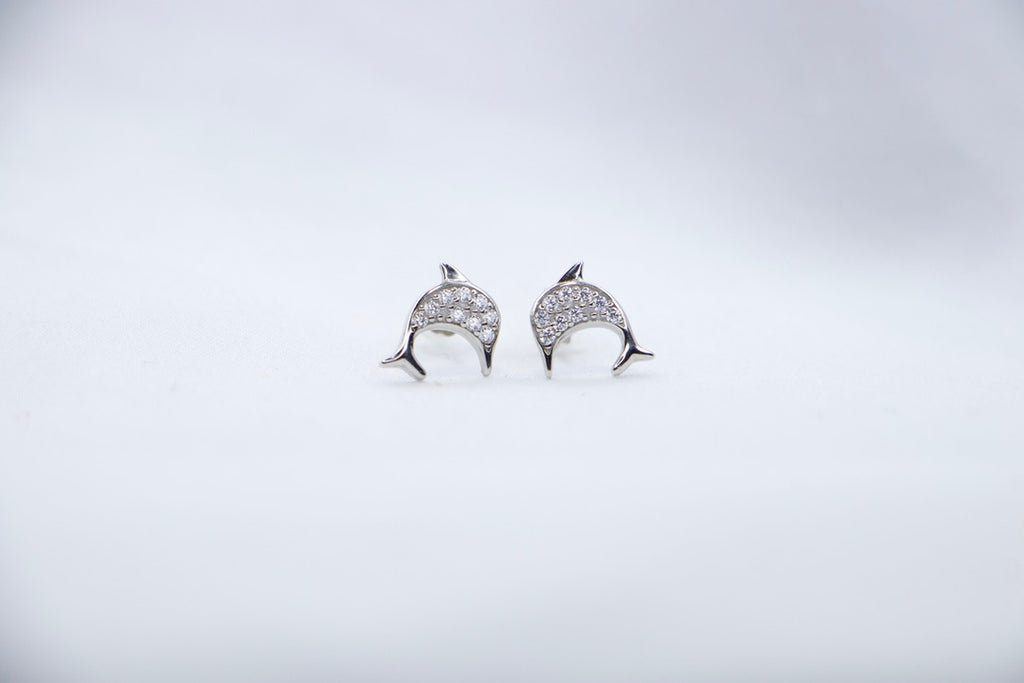 Lunar Dolphin Studs, front view showcasing delicate dolphin design with sparkling details.