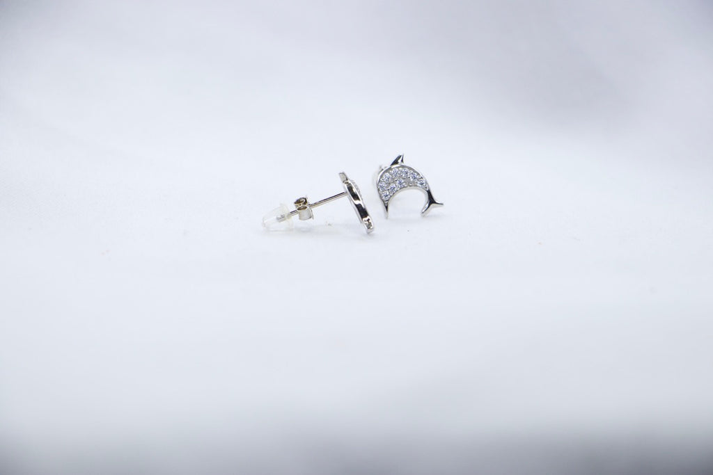 Lunar Dolphin Studs, side view showcasing delicate dolphin design with sparkling details.