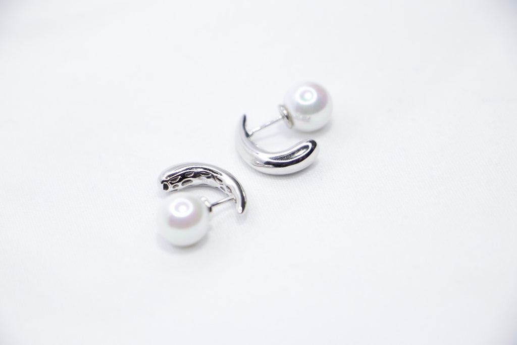 White gold pearl earrings, minimalist design, elegant, timeless, unique, and sophisticated front side view.