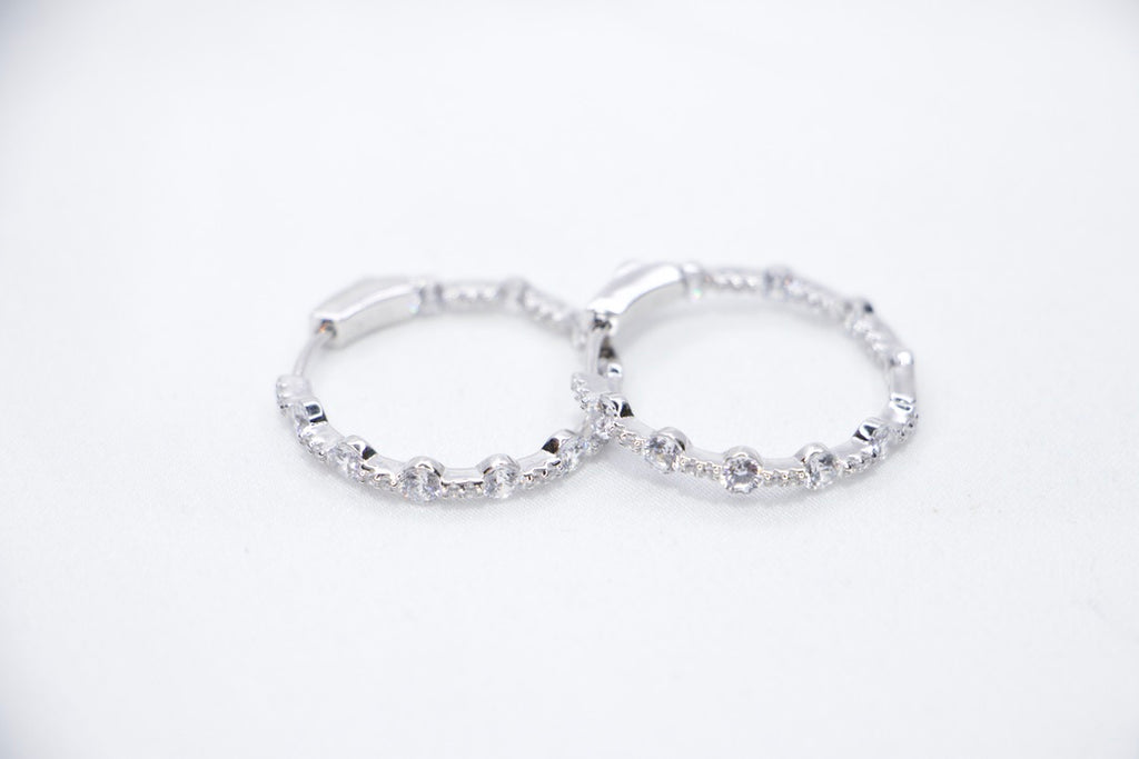 A pair of Lustrous Luxe Hoop Earrings crafted from 925 sterling silver, featuring bezel-set cubic zirconia stones in a sleek, lightweight hoop design, front view.
