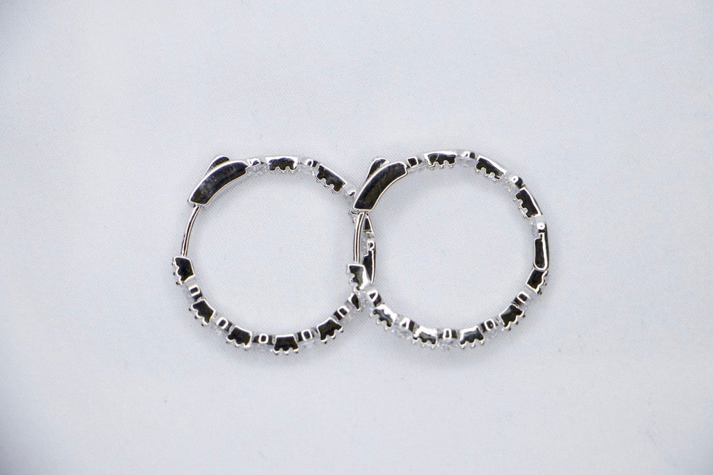 A pair of Lustrous Luxe Hoop Earrings crafted from 925 sterling silver, featuring bezel-set cubic zirconia stones in a sleek, lightweight hoop design, top view.