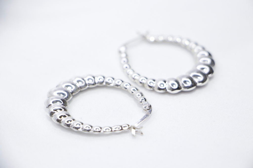 Lustrous Ripple Hoops in 925 sterling silver, featuring a sculpted, bubble-textured design with a high-polish finish, side view. 
