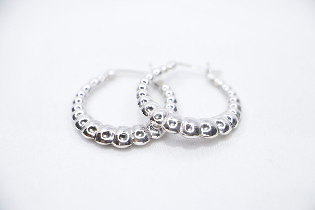 Lustrous Ripple Hoops in 925 sterling silver, featuring a sculpted, bubble-textured design with a high-polish finish, front view. 