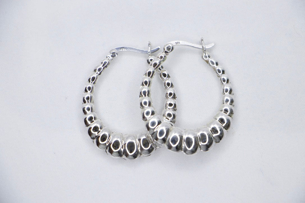 Lustrous Ripple Hoops in 925 sterling silver, featuring a sculpted, bubble-textured design with a high-polish finish, top view. 