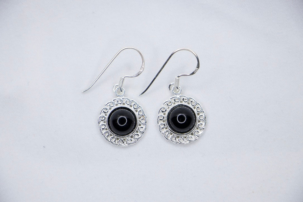 Midnight Elegance Drop Earrings featuring a black onyx gemstone encircled by intricate silver filigree, with a secure hook closure for an elegant look, top view.