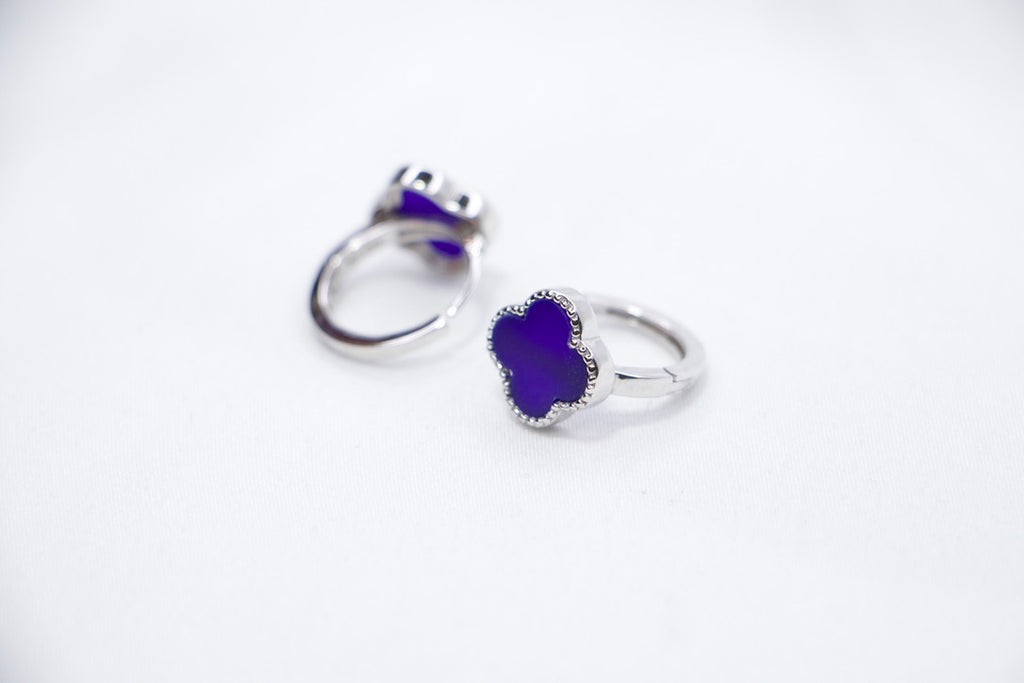 Purple Elegance sterling silver earrings featuring a round purple gemstone surrounded by delicate beaded silver accents sides view.