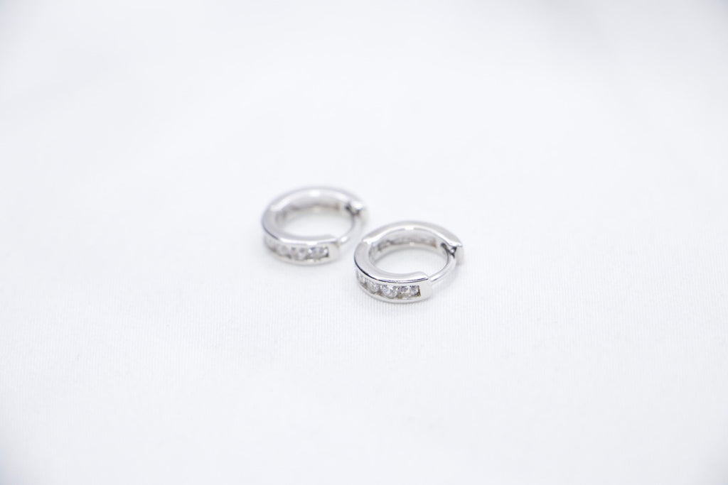 Sterling silver huggie hoop earrings with cubic zirconia, lightweight, hypoallergenic, elegant side view.