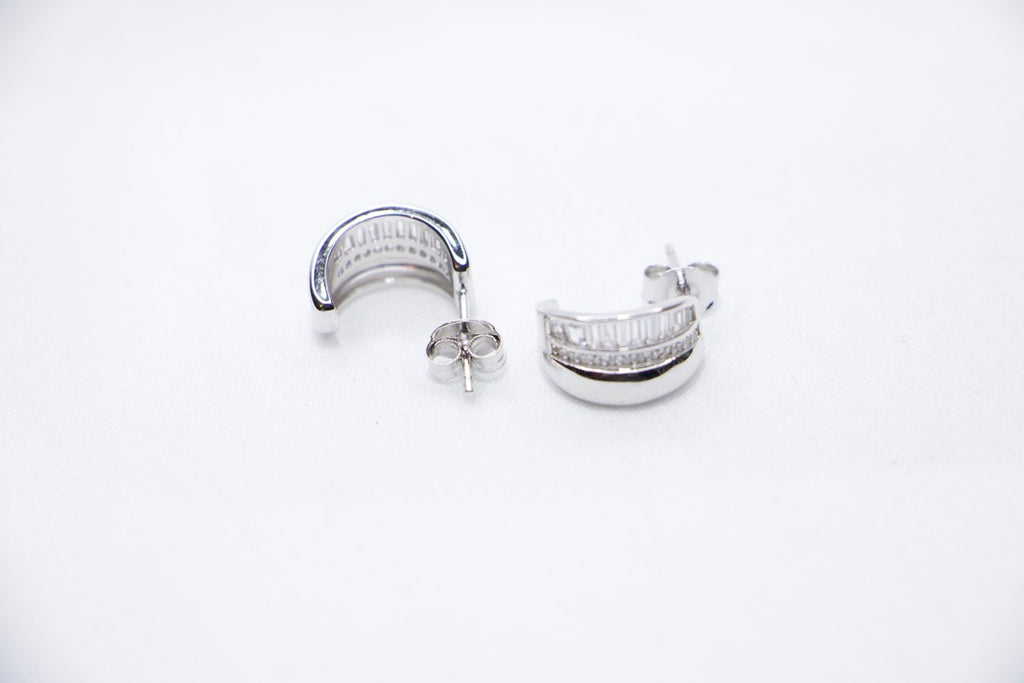Radiant Allure sterling silver hoop earrings featuring a stunning row of baguette-cut cubic zirconia stones sides view.