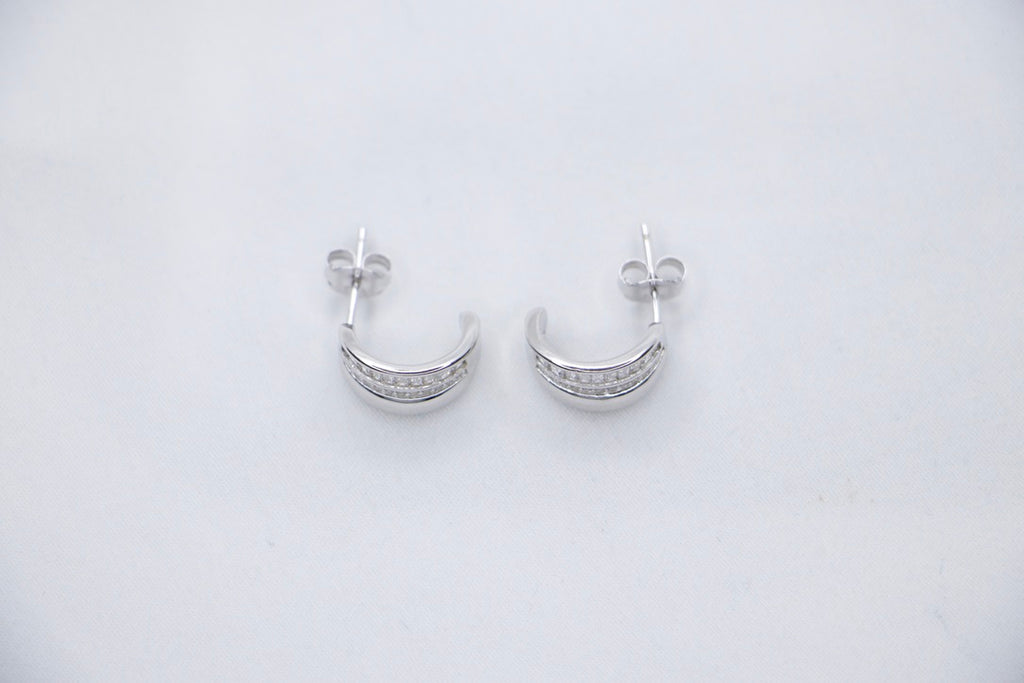Radiant Allure sterling silver hoop earrings featuring a stunning row of baguette-cut cubic zirconia stones top side view.