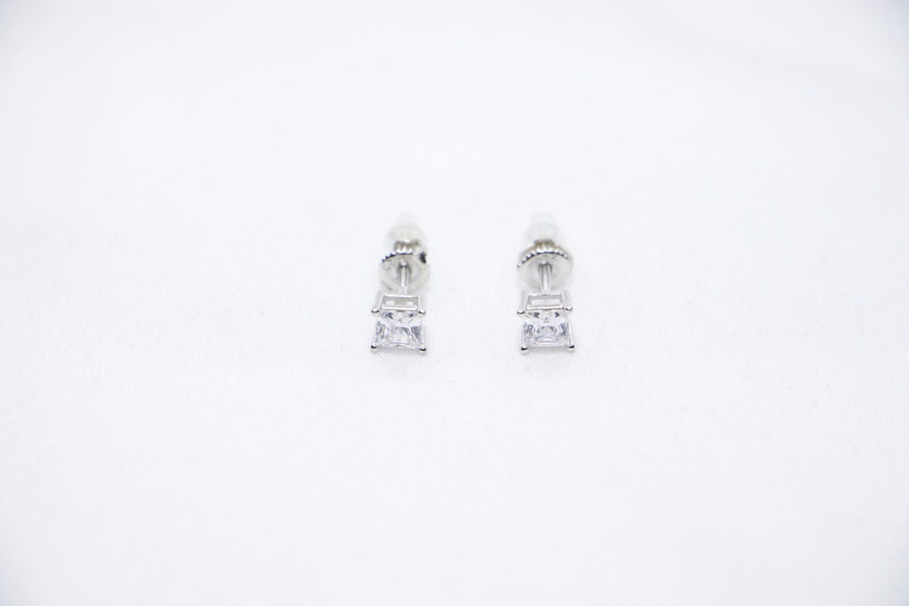 A Radiant Luxe Stud Earrings featuring a rectangular-cut cubic zirconia set in sterling silver, offering a modern and radiant look, front view.