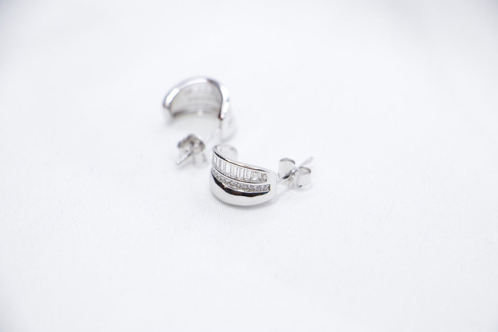 Radiant Allure sterling silver hoop earrings featuring a stunning row of baguette-cut cubic zirconia stones sides view.