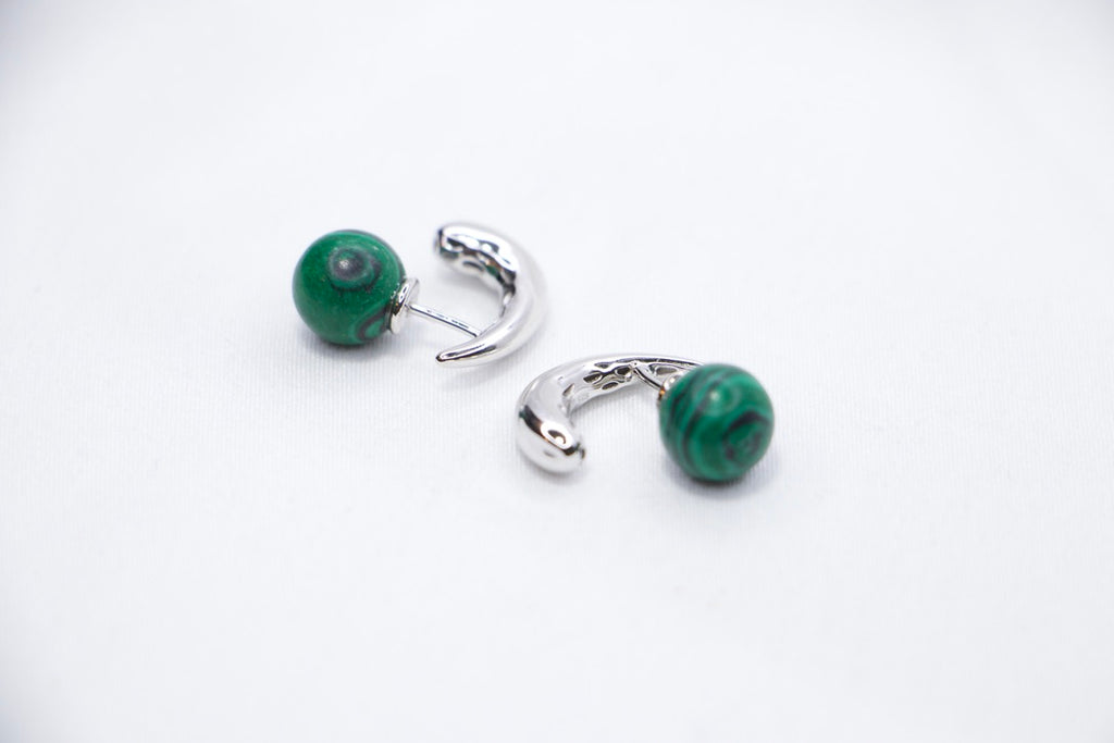 Close-up of Serpentine Dream Malachite Earrings featuring vibrant green malachite spheres set in a curved side views.