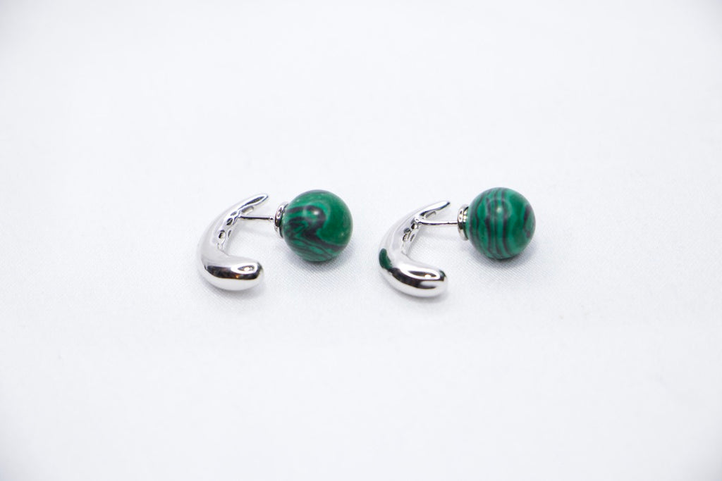 Close-up of Serpentine Dream Malachite Earrings featuring vibrant green malachite spheres set in a curved side view.