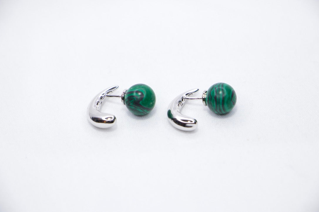 Close-up of Serpentine Dream Malachite Earrings featuring vibrant green malachite spheres set in a curved side view.