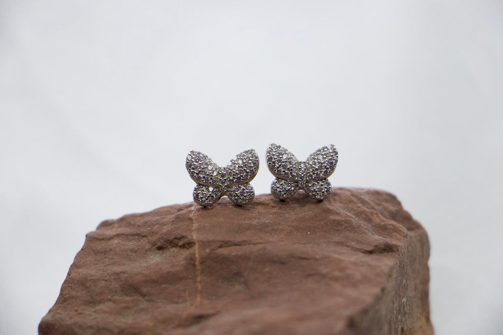 Sparkling Butterfly Stud Earrings in Sterling Silver with Clear Crystals - rock view. 