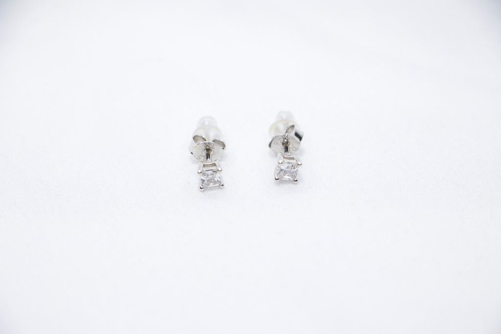 Timeless Sparkle Stud Earrings featuring square-cut cubic zirconia stones set in sterling silver with a radiant sparkle, front view.