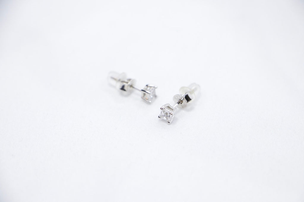 Timeless Sparkle Stud Earrings featuring square-cut cubic zirconia stones set in sterling silver with a radiant sparkle, side view.