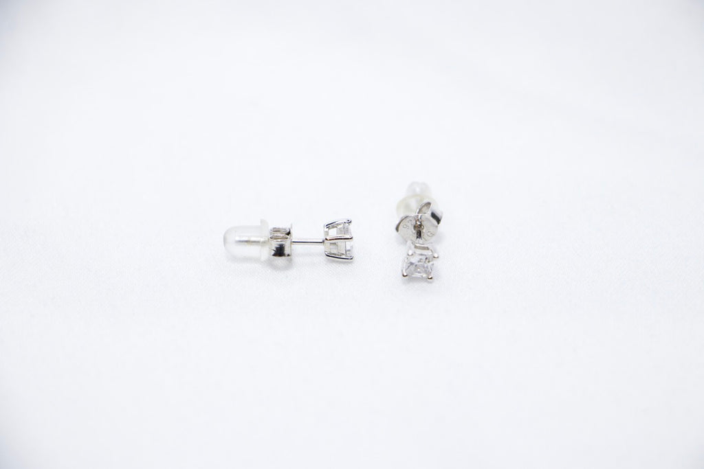 Timeless Sparkle Stud Earrings featuring square-cut cubic zirconia stones set in sterling silver with a radiant sparkle, sides view.