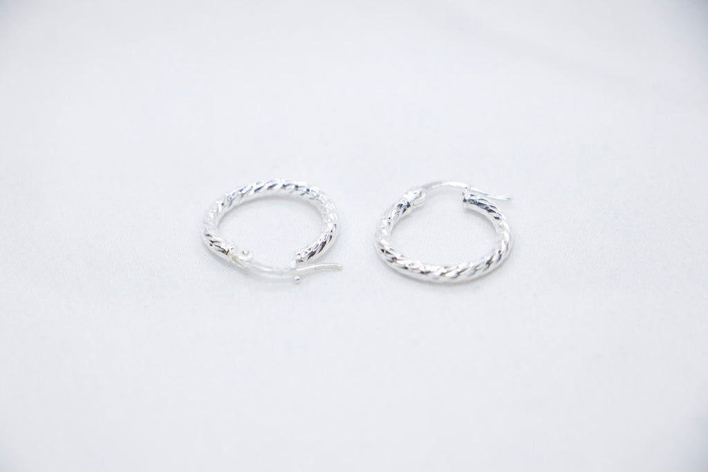 Twisted Charm Hoop Earrings in sterling silver featuring a beautifully twisted design, creating a dynamic texture side views.