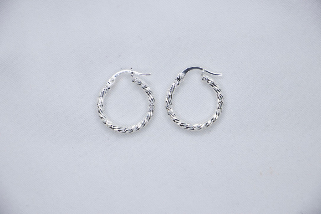 Twisted Charm Hoop Earrings in sterling silver featuring a beautifully twisted design, creating a dynamic texture top view.