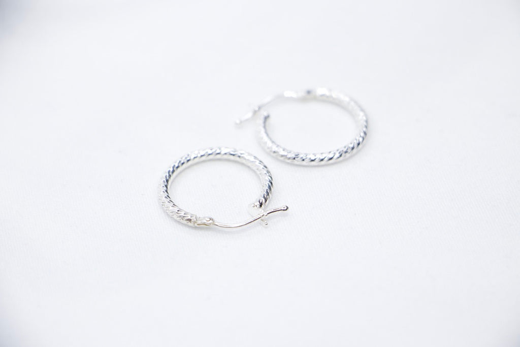 Sterling silver twisted hoop earrings, elegant braided design, lightweight, classic jewelry side views.