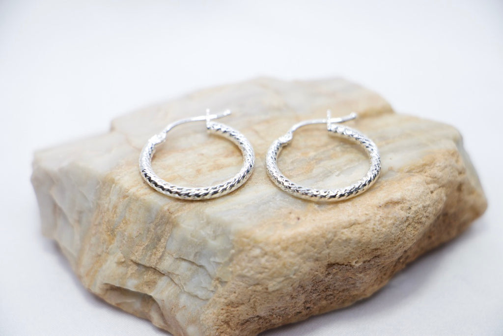 Sterling silver twisted hoop earrings, elegant braided design, lightweight, classic jewelry on Rock.