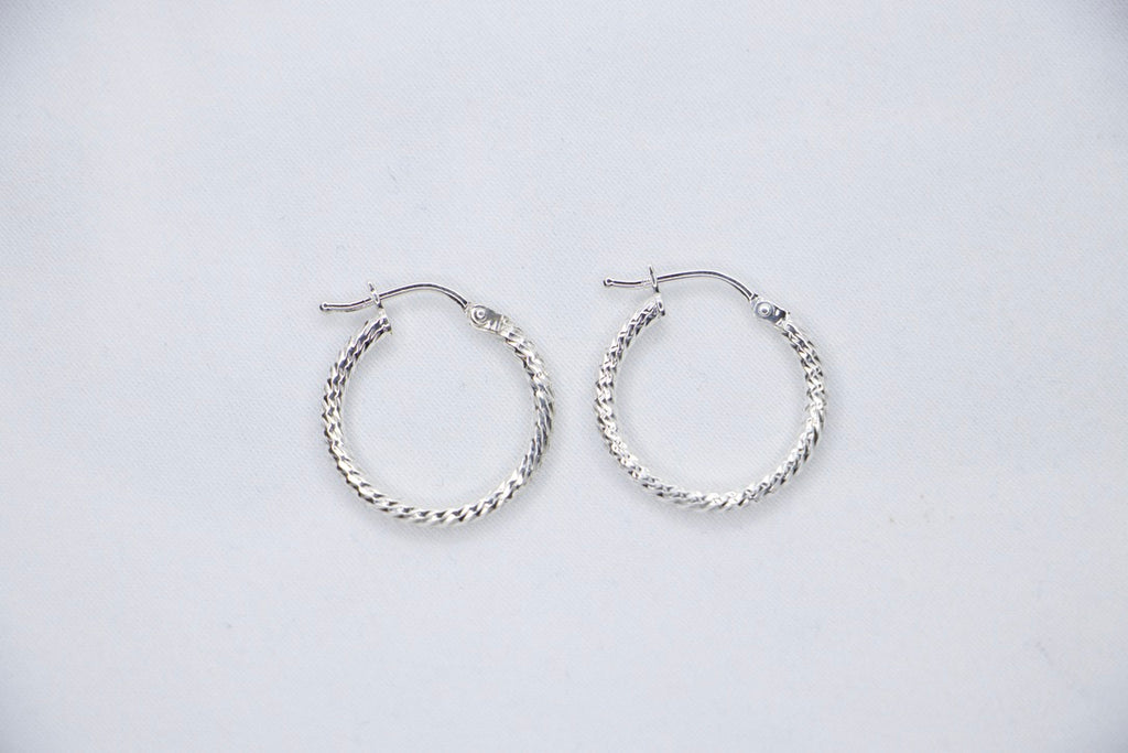 Twisted Luxe Hoop Earrings - Elegant Silver Design, Fine Jewelry for Women, top view.