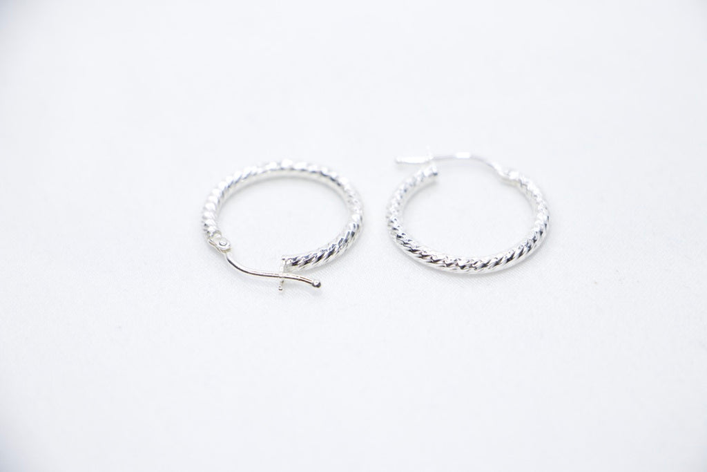 Twisted Luxe Hoop Earrings - Elegant Silver Design, Fine Jewelry for Women, top side view.