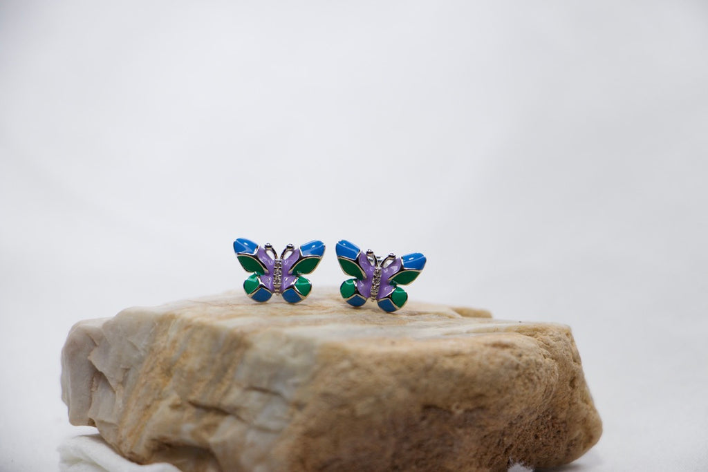 Colorful Butterfly Stud Earrings in Sterling Silver with Blue, Green, and Purple Enamel rock view. 